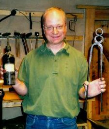 The happy blacksmith with his tongs