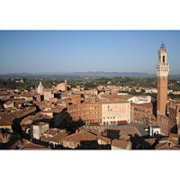 The Piazza del Campo in historic Siena, showing the iconic Torre del Mangia tower and hilly Tuscan landscape in the background. Photo from Wikipedia.