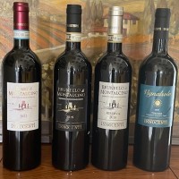 Four wine bottles lined up on counter